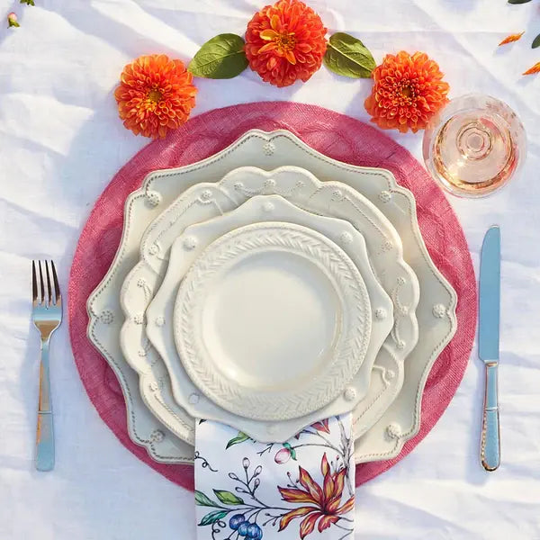 Whitewash ceramic scalloped charger plate with a classic round silhouette.