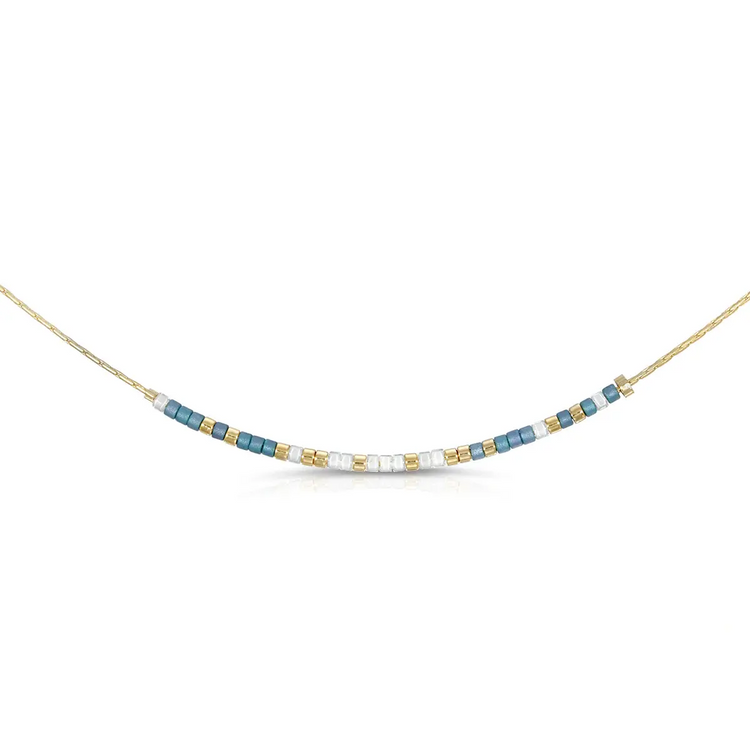 Morse code necklace with iridescent denim blue and shimmering white glass beads on a silver chain.