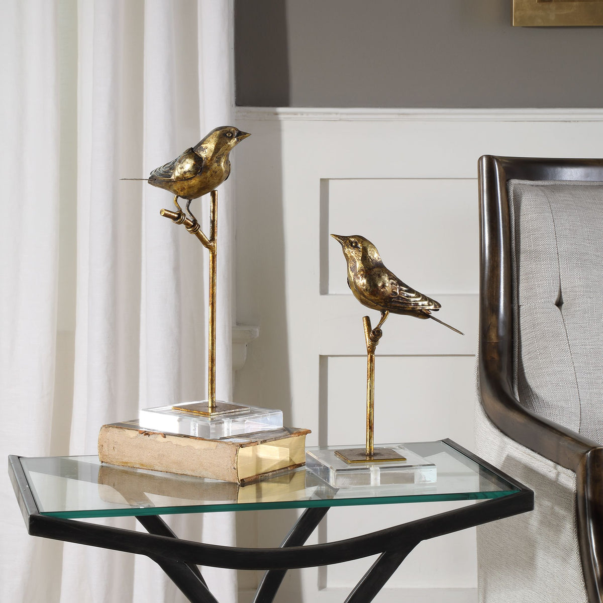 Set of two small sculpted bird figures with naturalistic silhouettes in earth-toned finish.