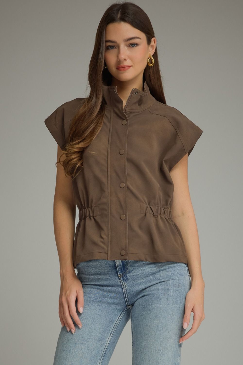 Woman wearing a Sarah Solid Cap Sleeve Jacket in brown with blue jeans.