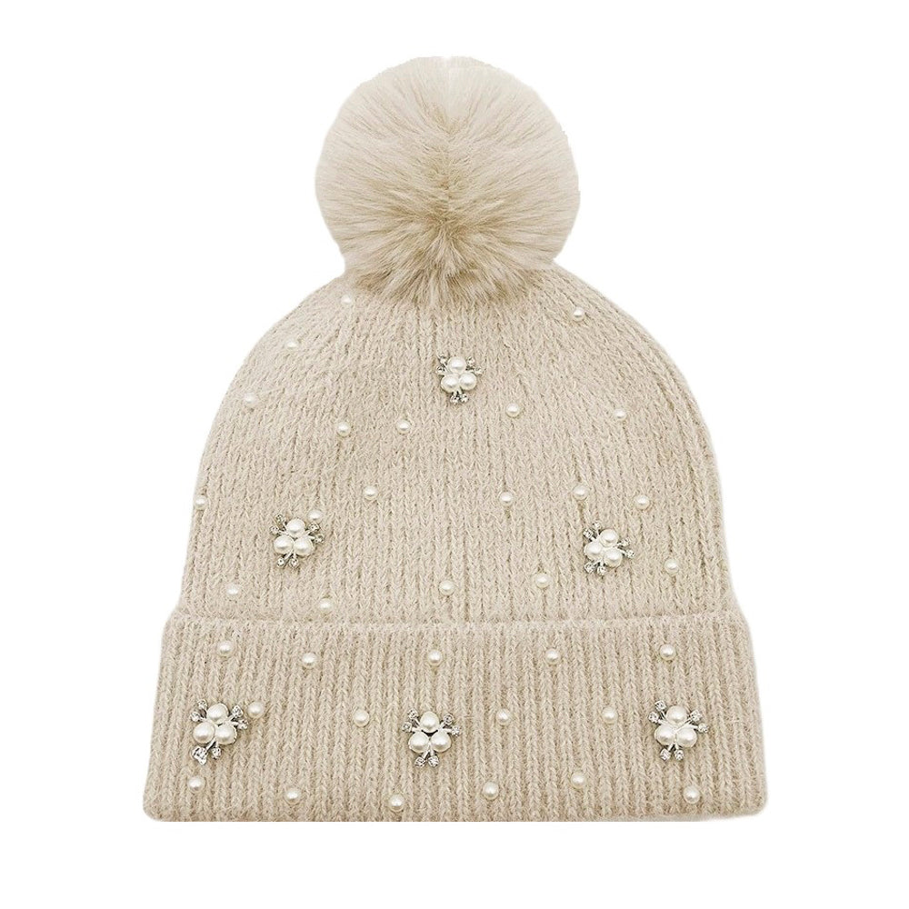 Black knit beanie with fluffy pom pom top, pearl studs around the brim.