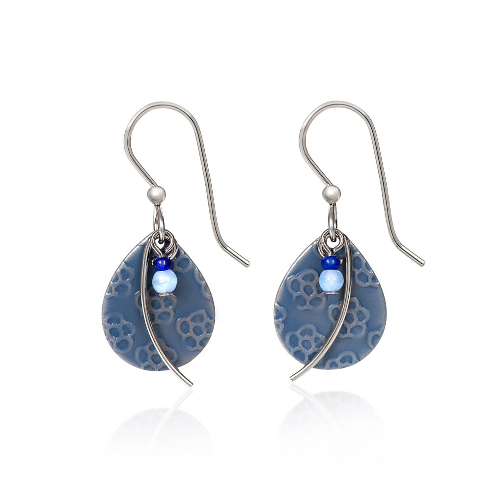 Blue teardrop earrings with flower texture, silver-tone wisps, and light blue bead accents.