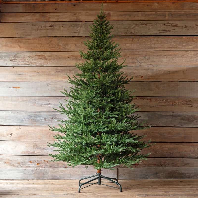 9-foot Olympia Fir artificial Christmas tree with warm white LED lights on a metal stand.