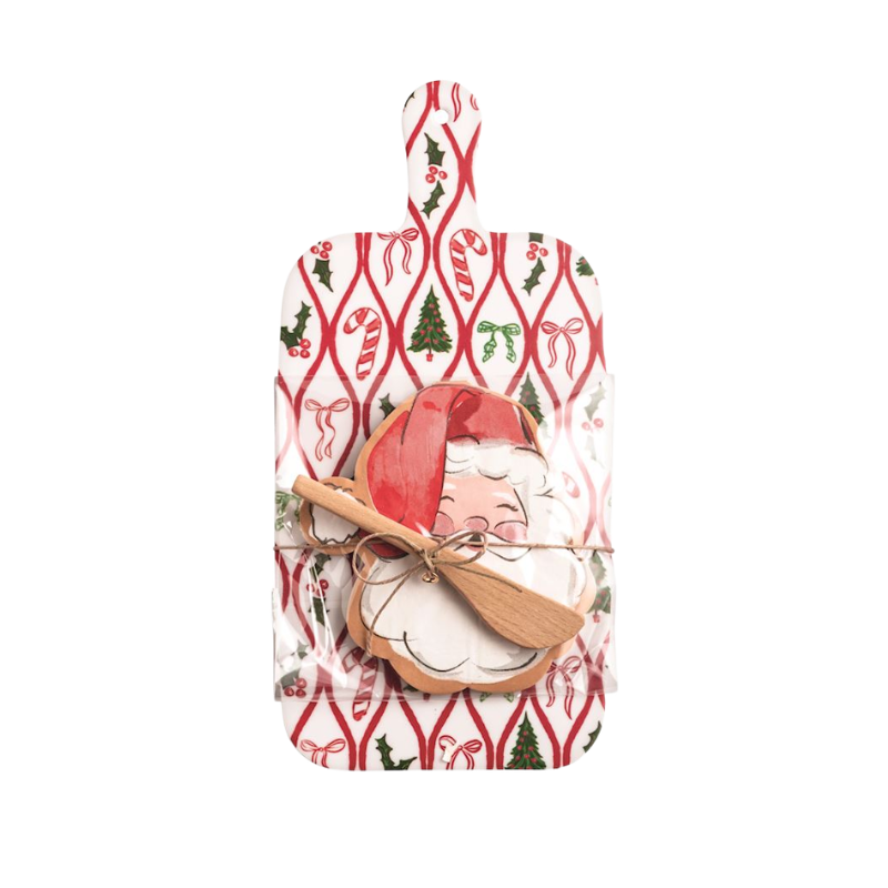 Christmas melamine paddle board set with Santa napkins and a wooden spreader tied with twine.