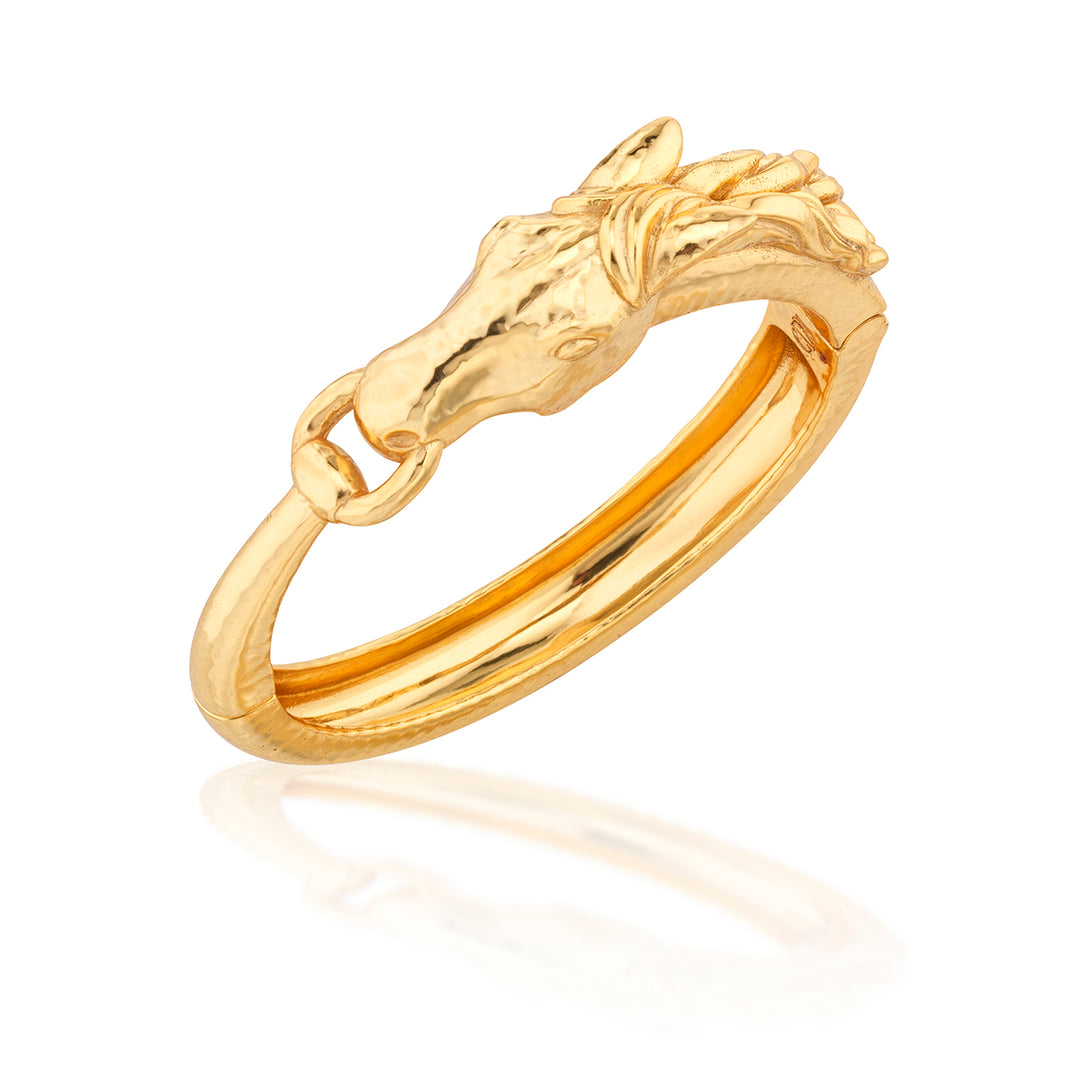 Gold equestrian hinged bangle featuring a sculpted horsehead with mane and bit details.