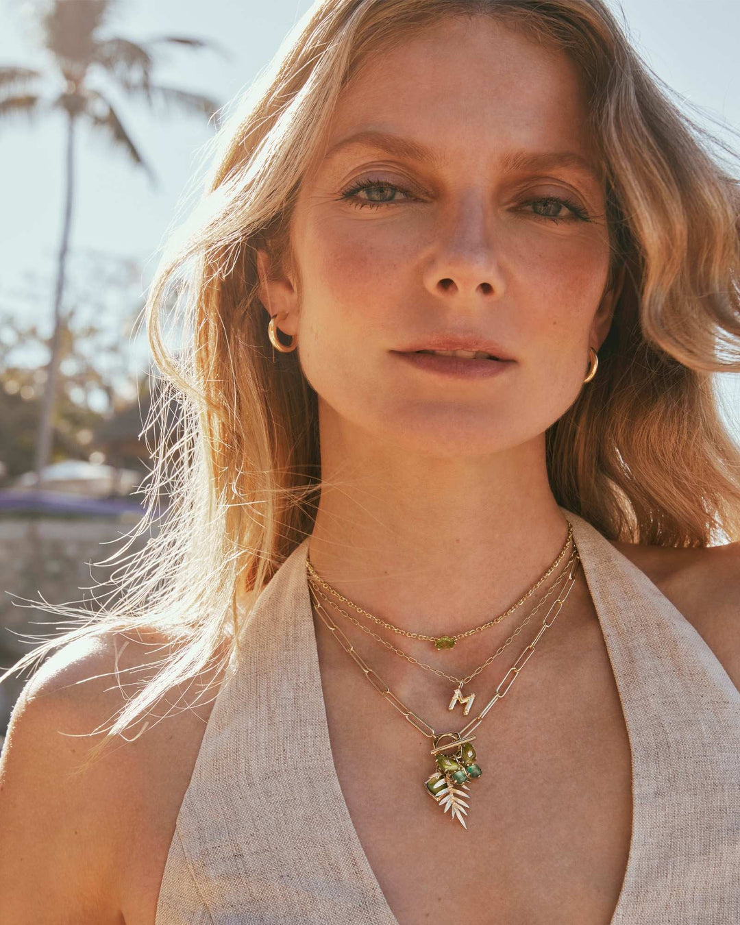Gold toggle necklace featuring a butterfly charm pendant on an 17-inch chain.
