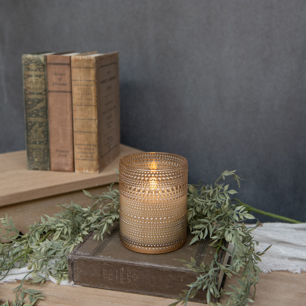 Five-inch champagne glass candle with dotted pattern featuring a three-dimensional flame shape.