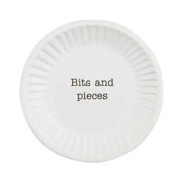 Round textured ceramic tapas plate in earthy tones with a rustic rim silhouette.