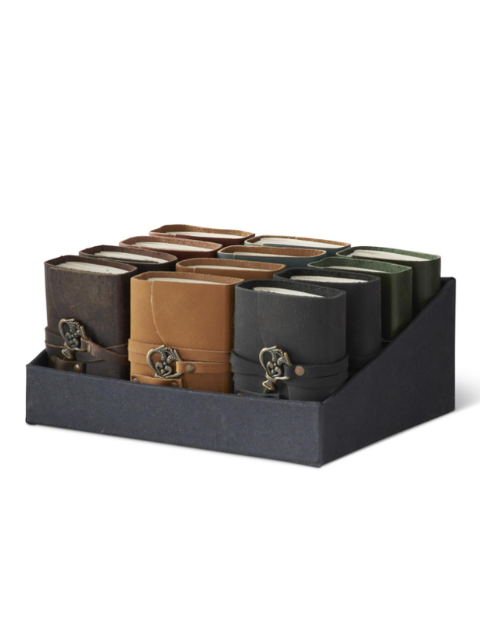 Display box of 4.5 inch handcrafted leather journals in various colors with unique key hardware.
