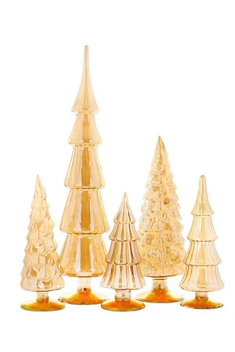 Amber-colored glass candle holder with a tree-inspired silhouette.