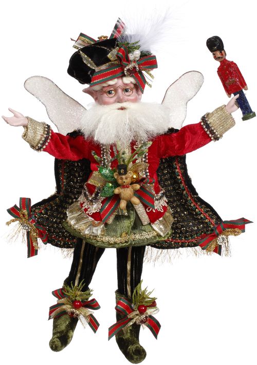A festive fairy figurine with white wings, a red jacket, black and gold skirt, and striped pants, holding a nutcracker toy.