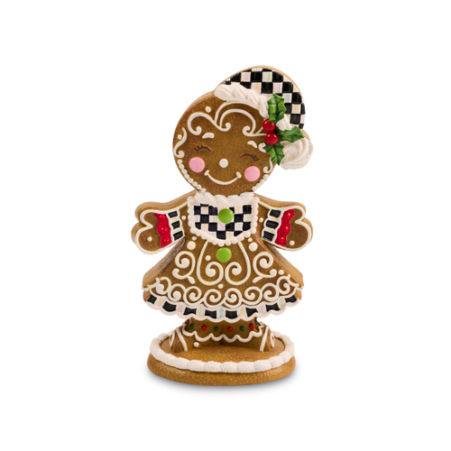 Gingerbread girl figurine with a checkered hat, dress, and white icing details on a round base.