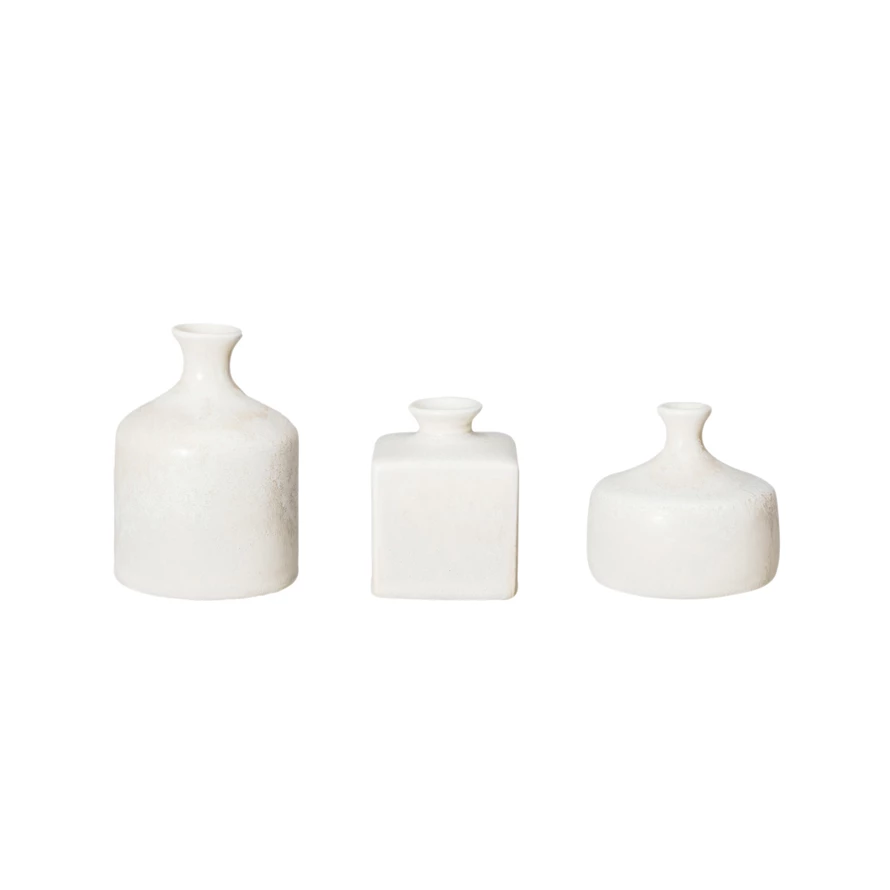 Set of three small stoneware vases in various shapes with a cream reactive glaze.