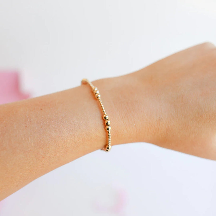 6.75-inch gold-filled Ily bracelet on an elastic string with a simple silhouette.