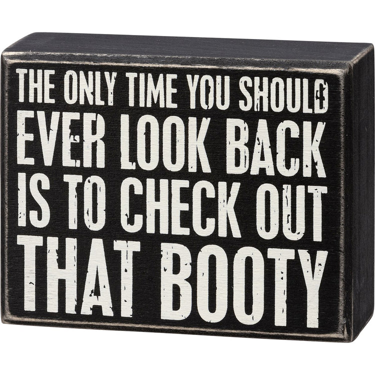 Black wooden box sign with white text: The only time you should ever look back is to check out booty