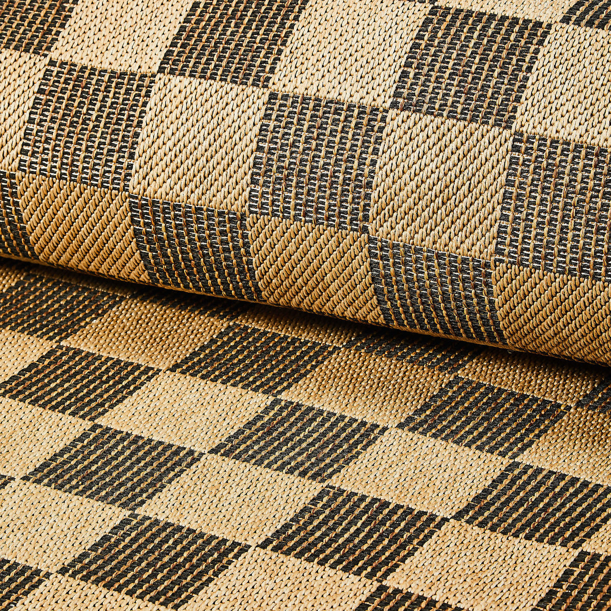 Black checkered indoor/outdoor rug made of polypropylene with a woven pattern.