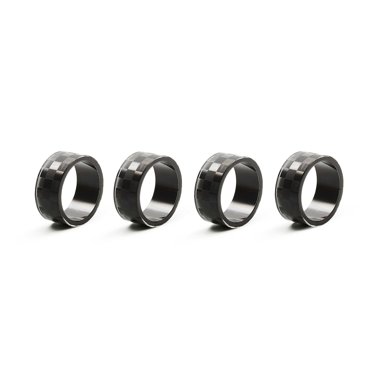 Set of four black check-pattern etched glass napkin rings with circular silhouette.