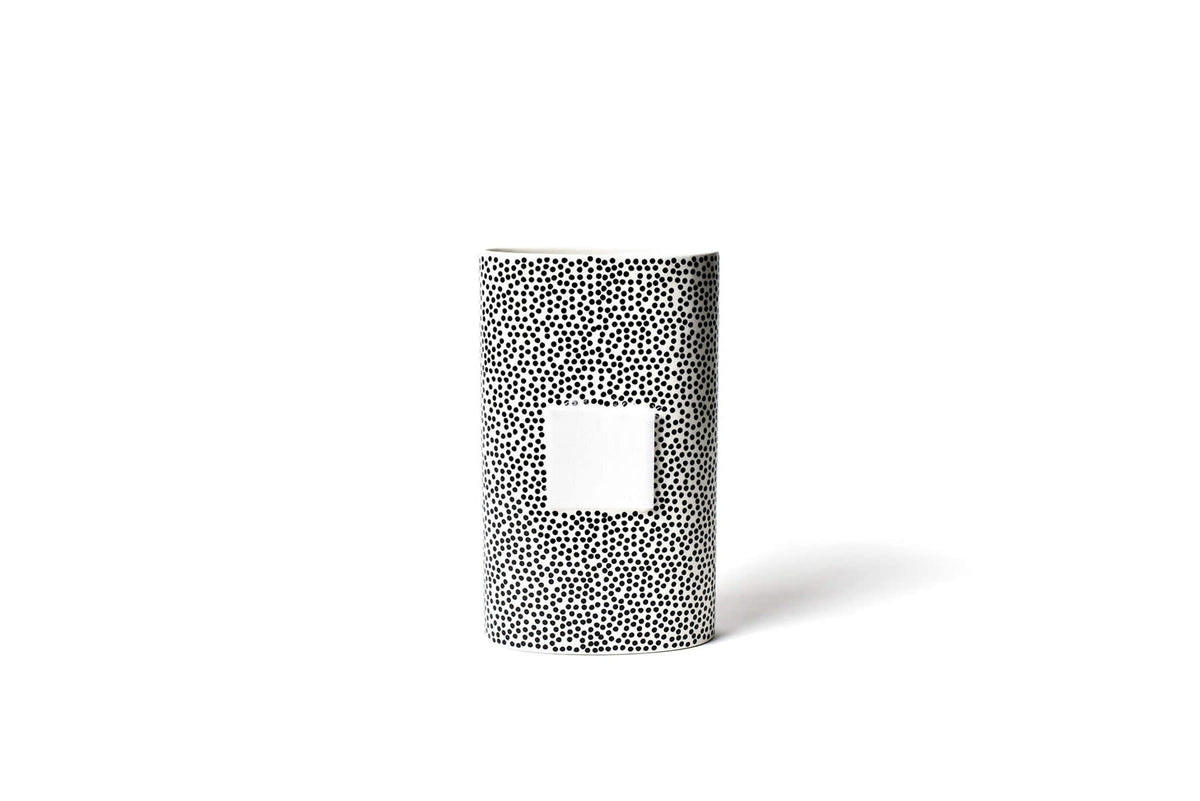 Black ceramic oval vase with small dot pattern on a white background