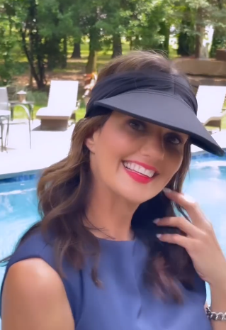 Black women's visor hat with wide brim, elastic closure, open top design, and contrasting pattern.