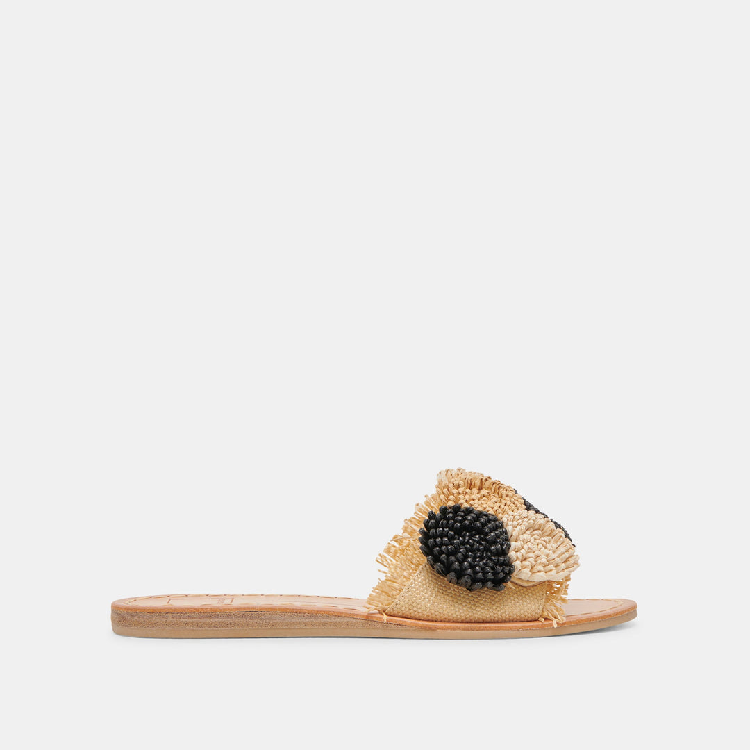 Side view of Danela Sandals featuring a tan raffia strap with black and cream pom-pom accents.