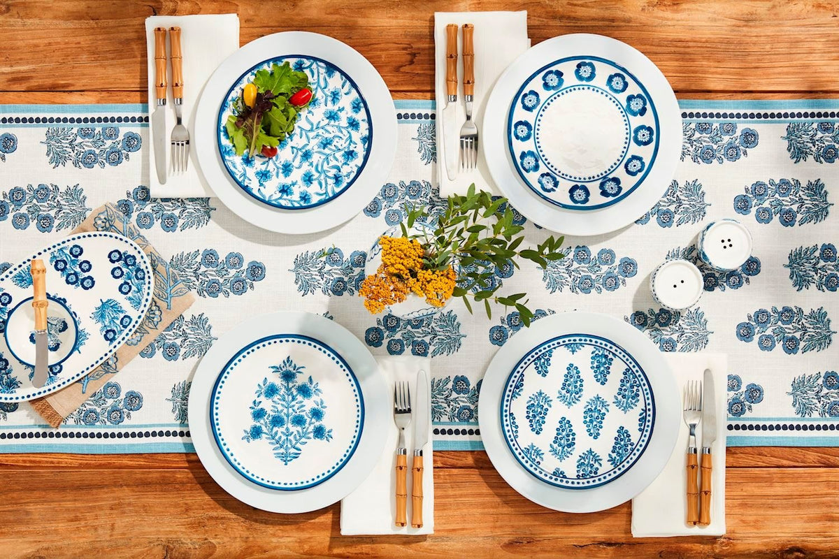 Block print cotton table runner with geometric patterns in earth tones on a rectangular silhouette.