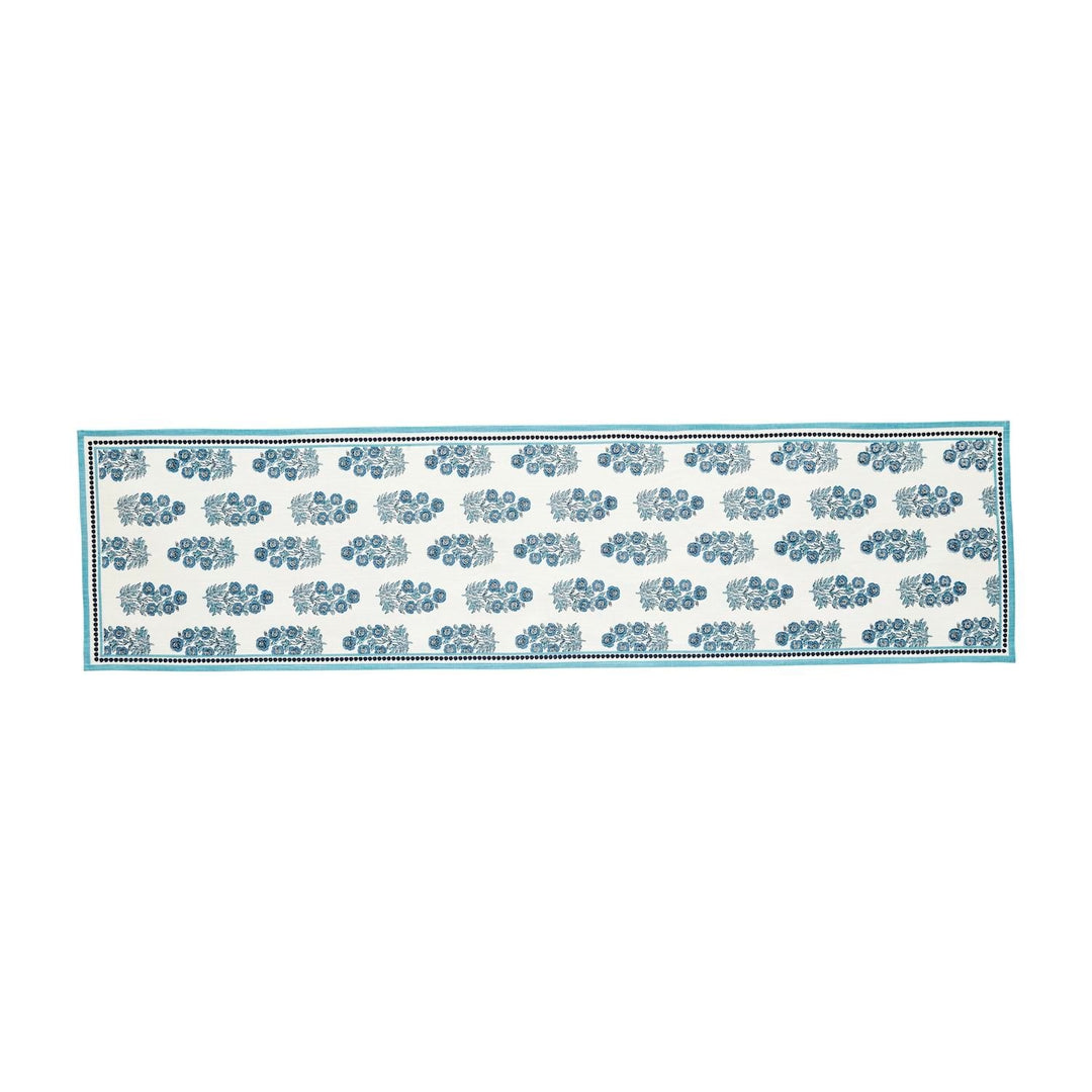Block print cotton table runner featuring a geometric pattern in earth tones on an off-white background.
