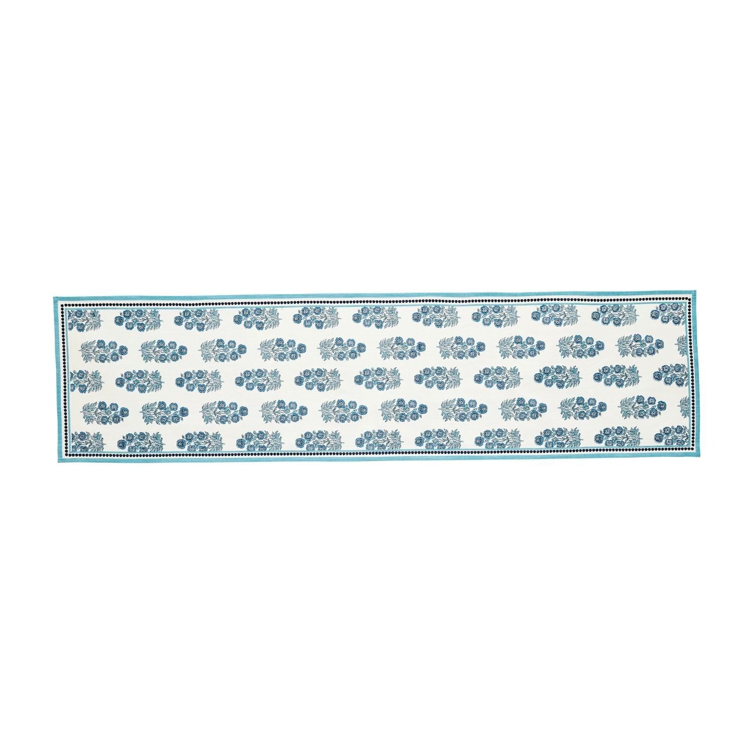 Block print cotton table runner featuring a geometric pattern in earth tones on an off-white background.