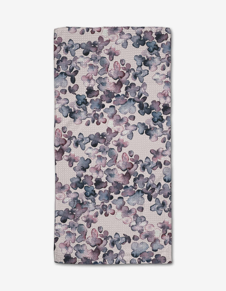 Mini kitchen towel in white with a subtle geometric print made from recycled materials.
