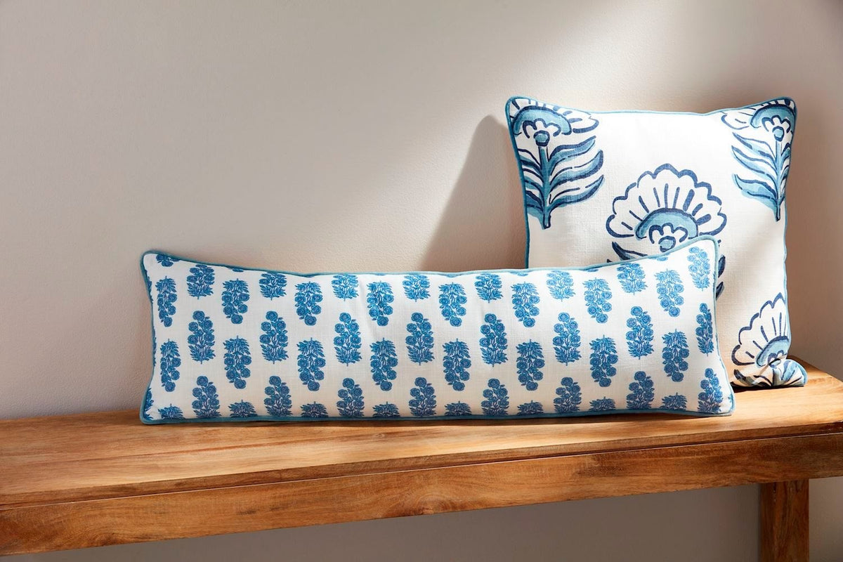 Blue block print cotton long pillow with contrast piped edge.