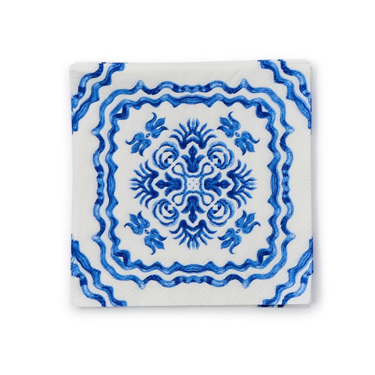 Blue tile block print cocktail napkin made of white paper with a Mediterranean coastal pattern.