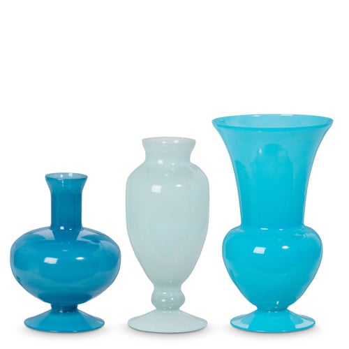 Blue glass vase with a cylindrical shape designed to hold fresh flowers.