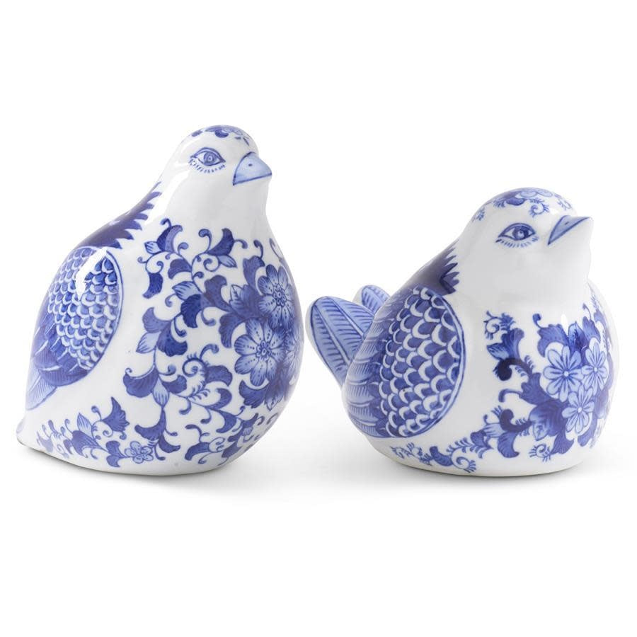 Blue and white porcelain sitting bird figurine with floral wing detail