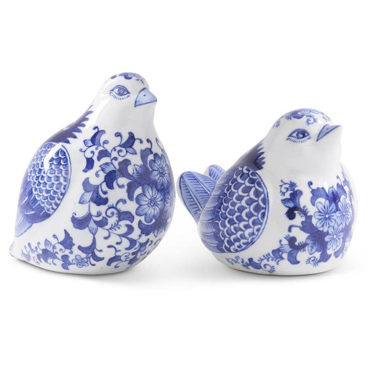 Blue and white porcelain sitting bird figurine with floral wing detail