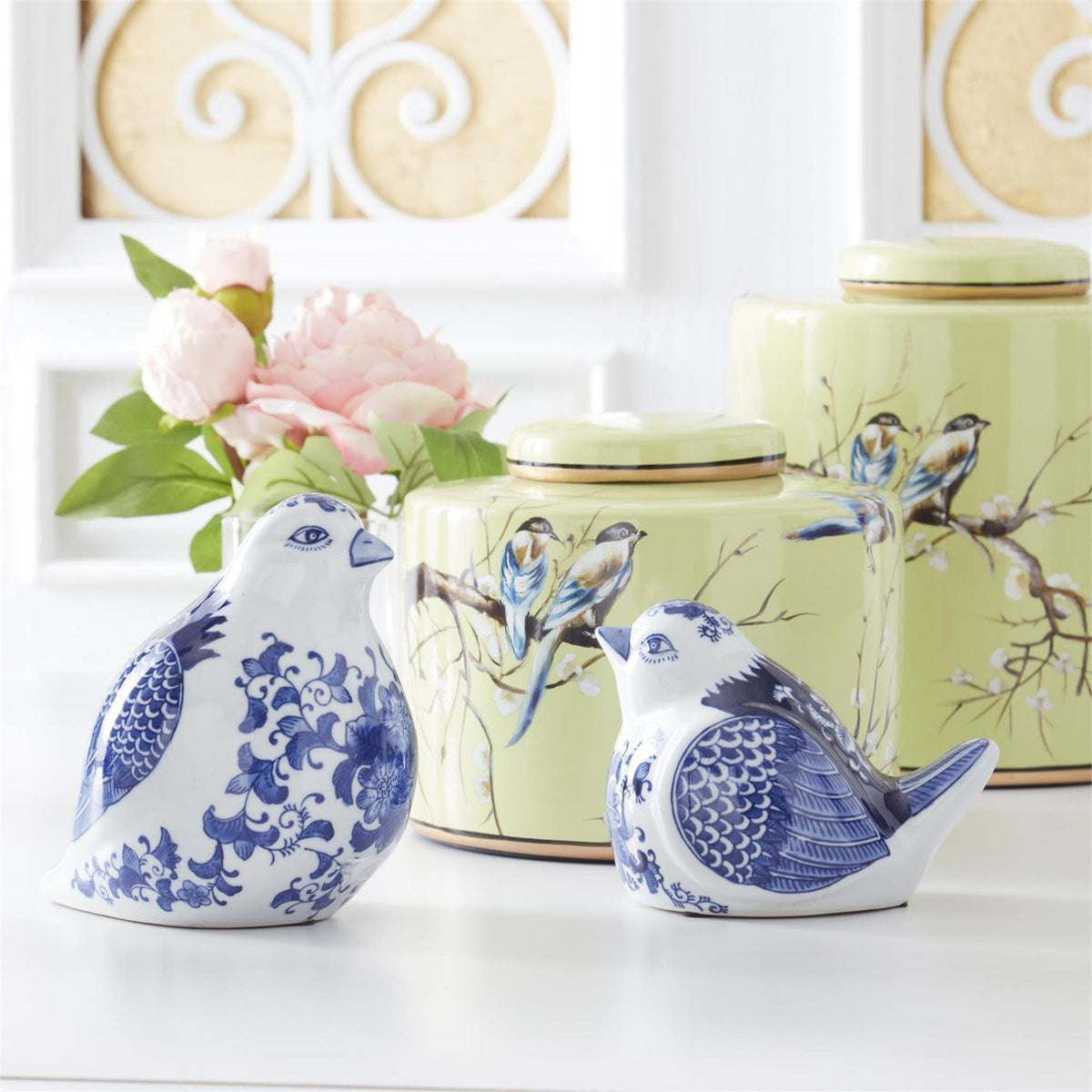 Blue and white porcelain sitting bird figurine with floral wing patterns