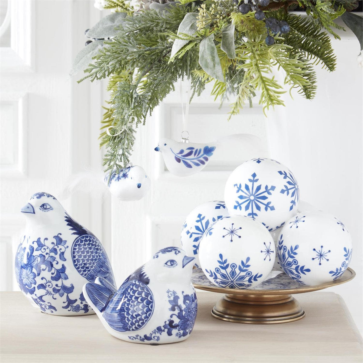 Blue porcelain sitting bird figurine with white floral wing patterns