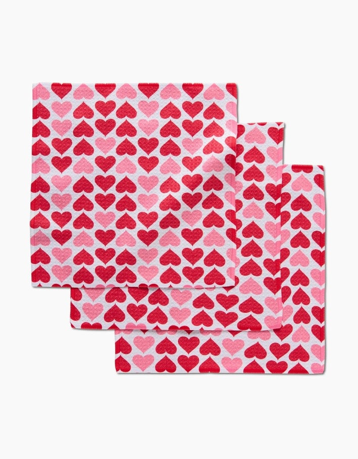 Set of three blushing heart-patterned waffle weave dishcloths with hang loops.
