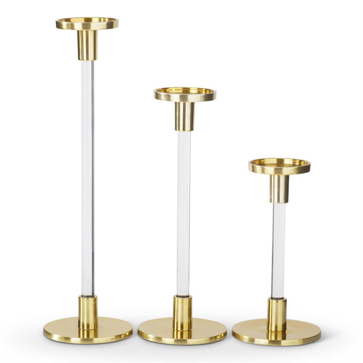 Set of three acrylic and gold metal taper candleholders in varying heights.