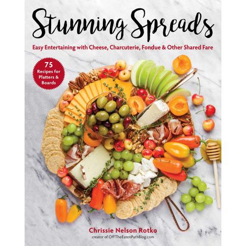 Book cover for Stunning Spreads featuring a colorful charcuterie board with cheese, fruit, and nuts.