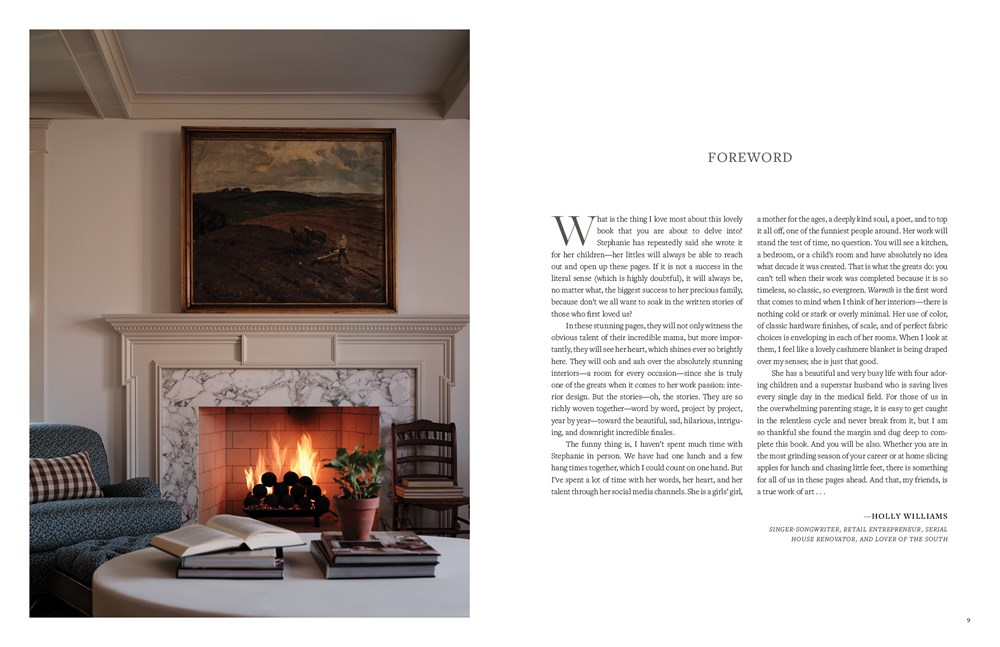 Open book 'Interiors of A Storyteller' showing a cozy living room with a fireplace and foreword.