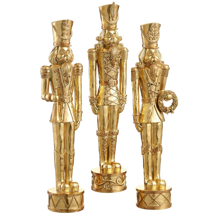 Gold resin nutcracker figurine with a classic soldier silhouette.
