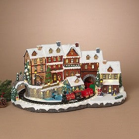 25.4-inch lighted musical holiday village with a moving red train and snow-covered buildings.