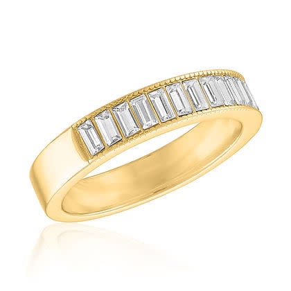 Stacked gold rings with a central baguette-cut stone on a white background.