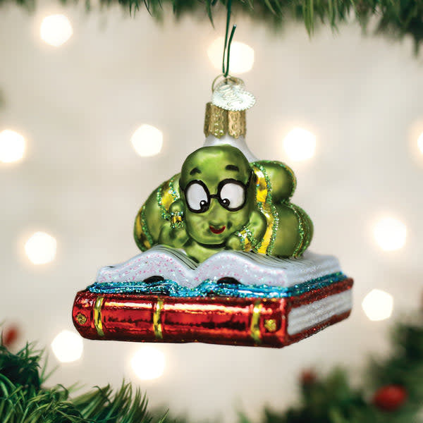 Small book-shaped ornament in dark brown with white page texture.