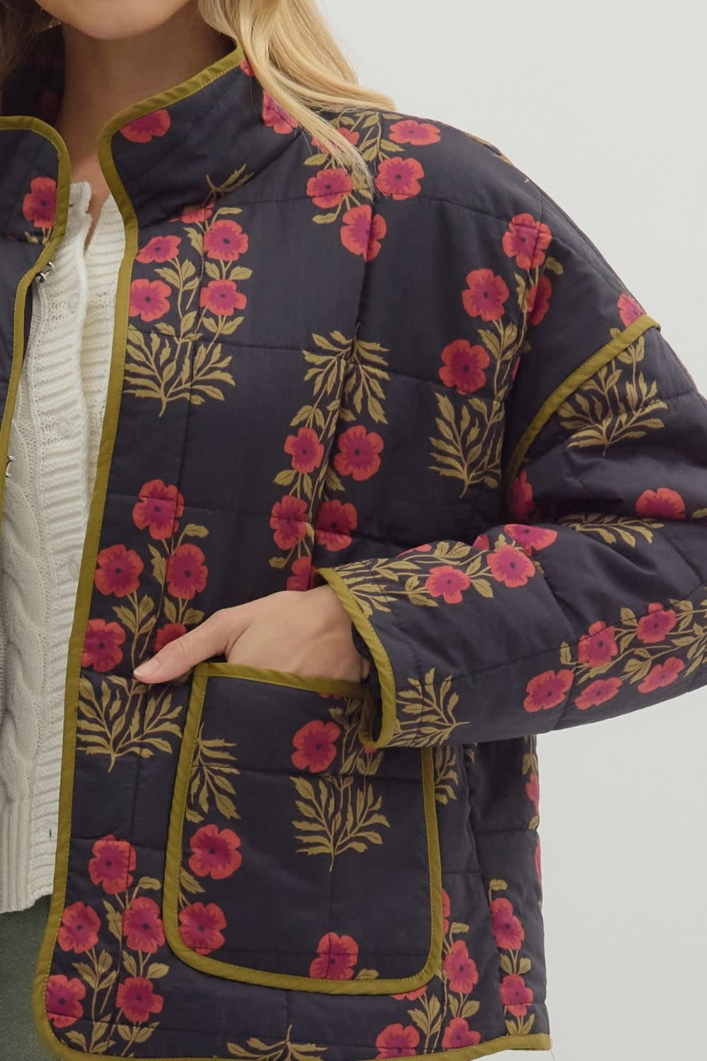 Black quilted botanical long-sleeve jacket with contrast binding.