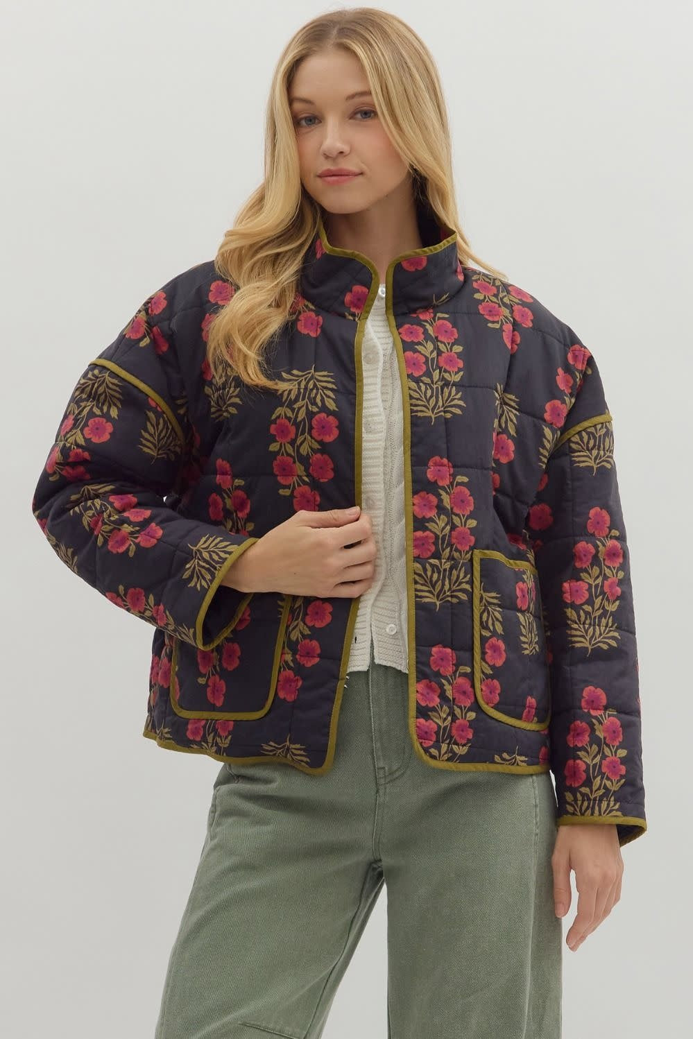 Black botanical quilted jacket with contrast binding and front patch pockets.