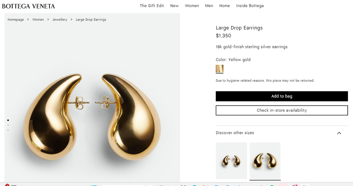 Metal stud earring featuring a three-dimensional tear-shaped charm with an organic silhouette.