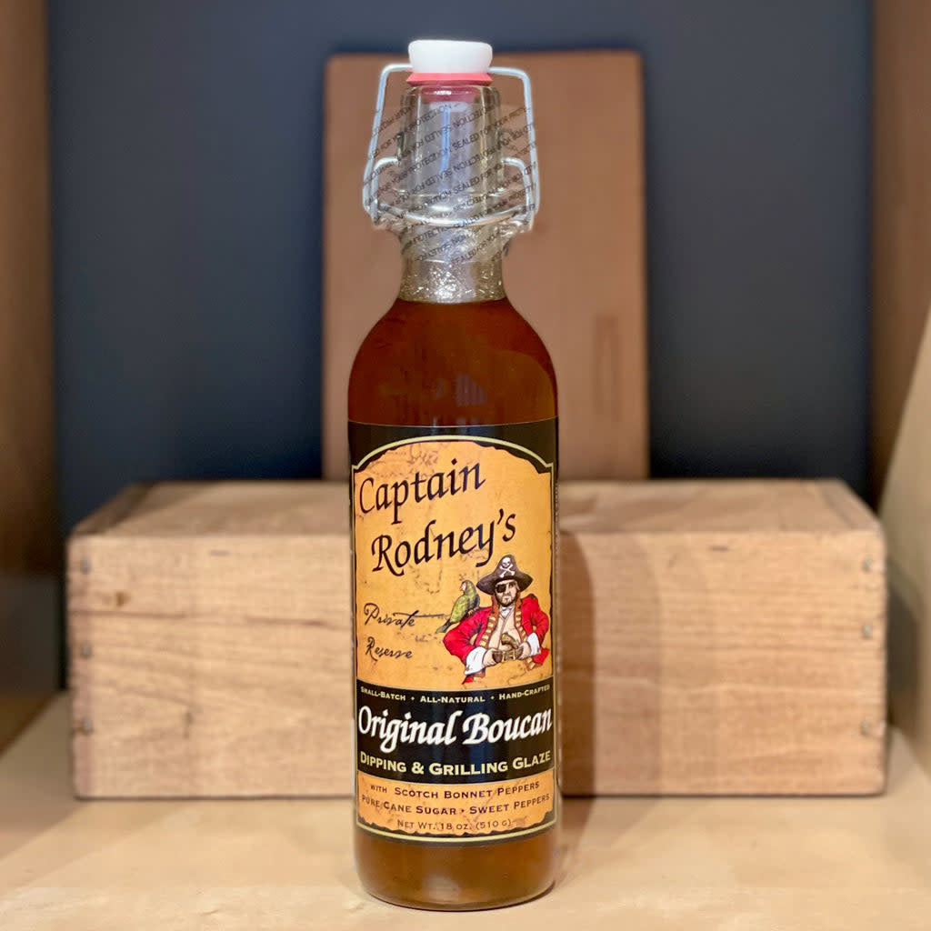 Bottle of Original Boucan Glaze Classic Edition peach barbecue sauce with a red label.