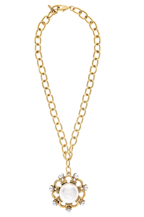 Maeve Necklace featuring a gold-tone chain and an ornate medallion with pearl accents.