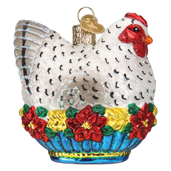 Glass French hen Christmas ornament with white feathers, red poinsettias, and a blue base.
