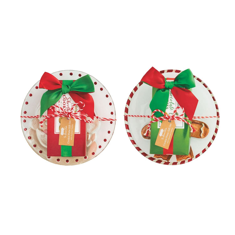 Two individual cookie plate gift sets with holiday-themed plates, boxed cookies, and festive bows.